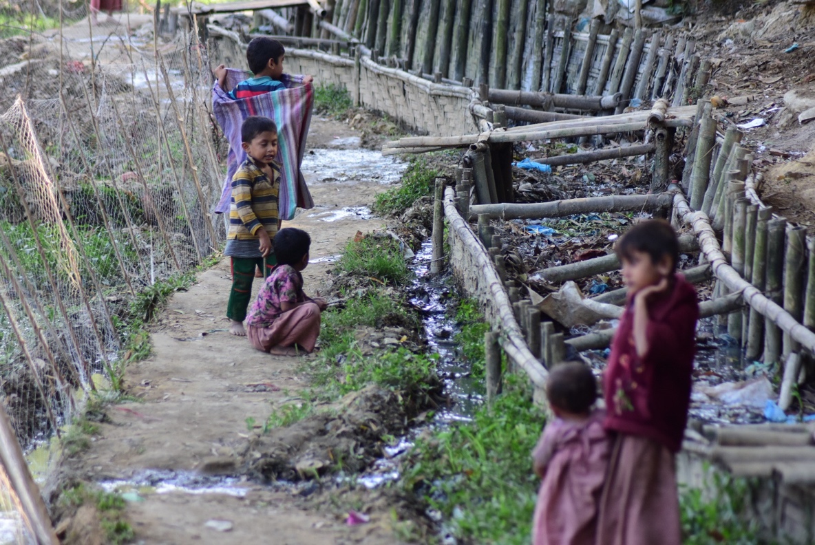 Children near open sewerage in Rohingya refugee camp in Cox's Bazar, Bangladesh